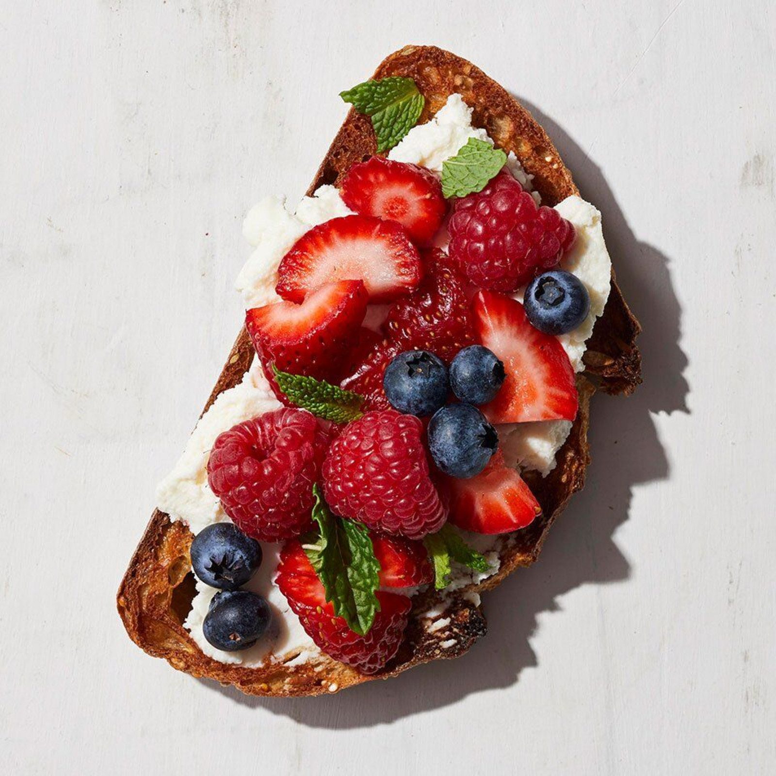 Sourdough toast topped with cottage cheese and mixed berries