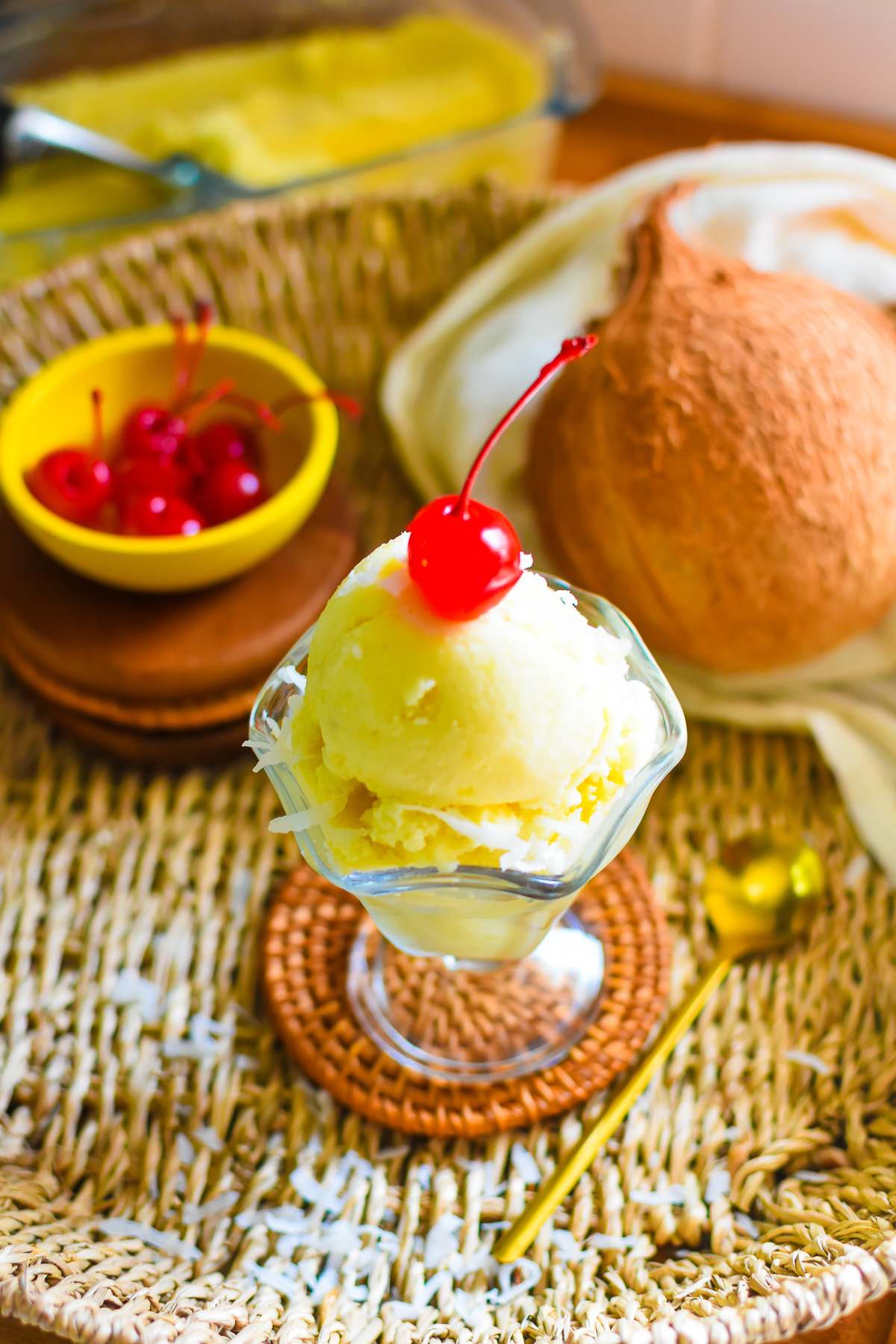 Pineapple coconut nice cream served in a glass dessert bowl
